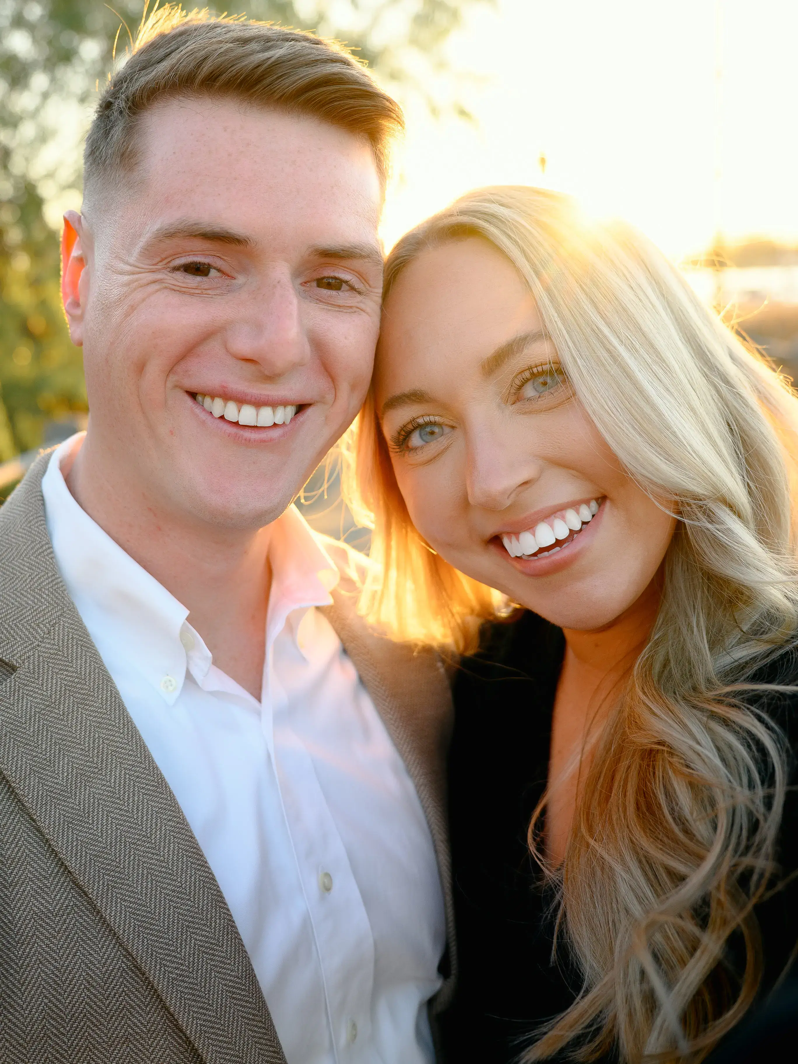 Brides laughing together in ocean waves, capturing authentic joy and playfulness