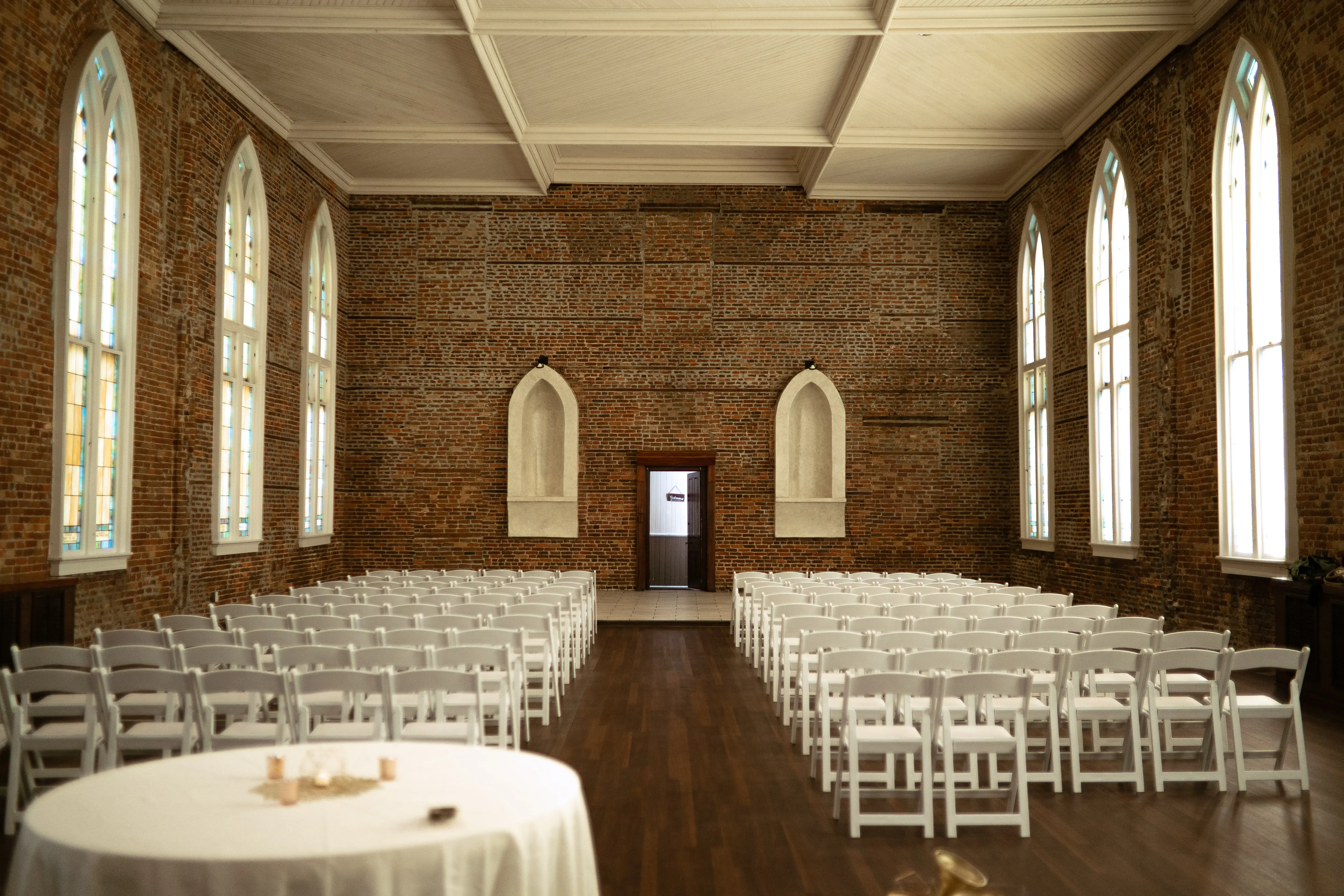 Elegant ceremony setup with atmospheric lighting and fine art styling