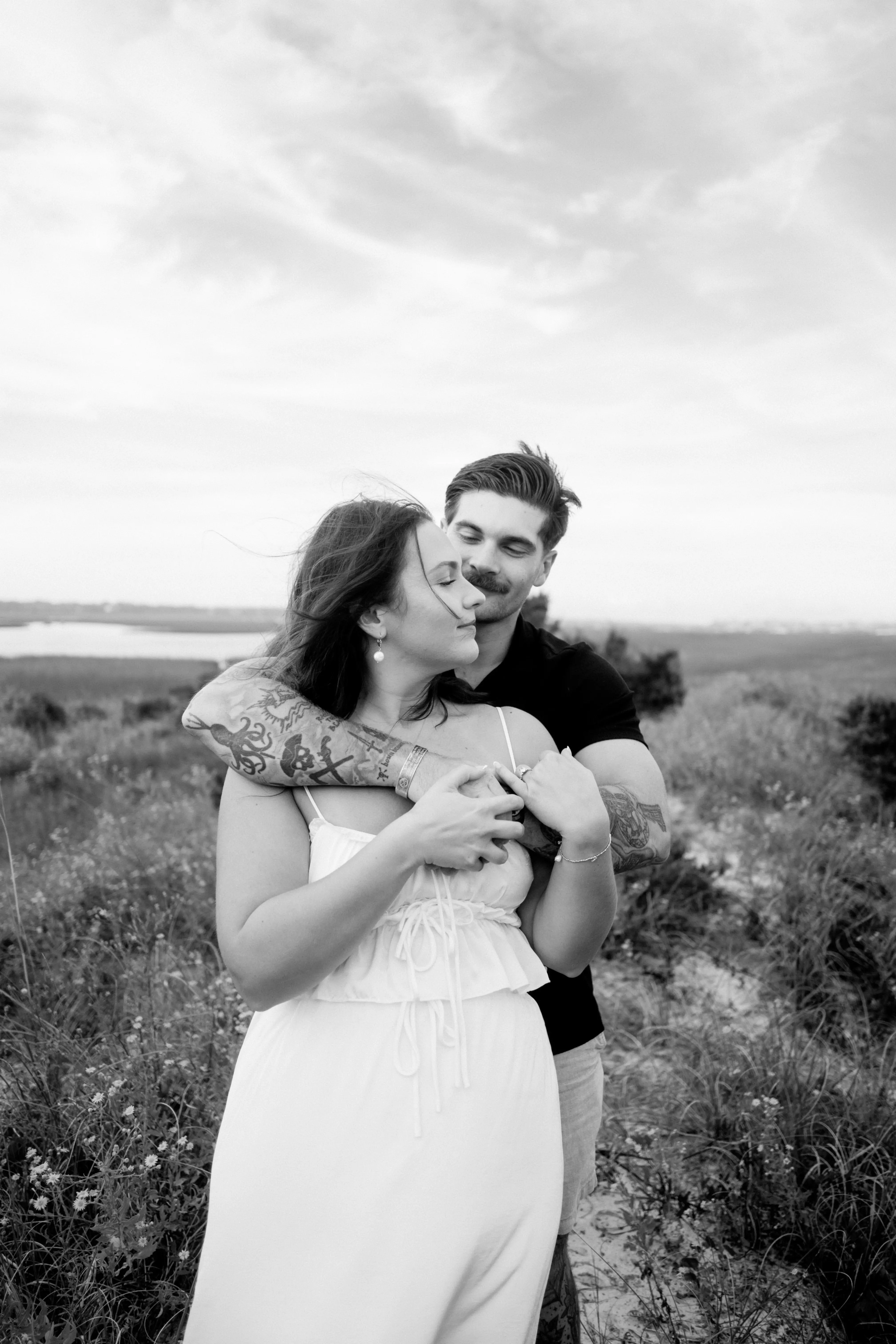 Peaceful embrace in open field, showing complete comfort and connection